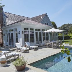 An outdoor area with a pool and patio furniture.