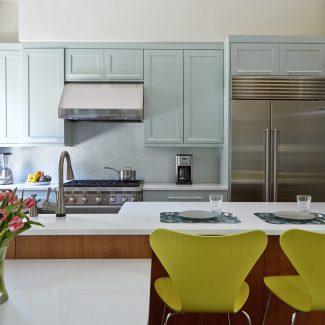 A kitchen with stainless steel appliances and a large island.